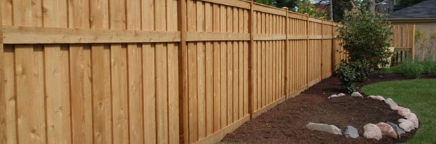 New wooden privacy fence with landscaping 