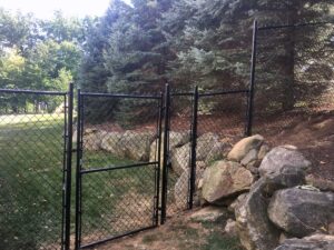 Black chain-link fence sectioning off a backyard